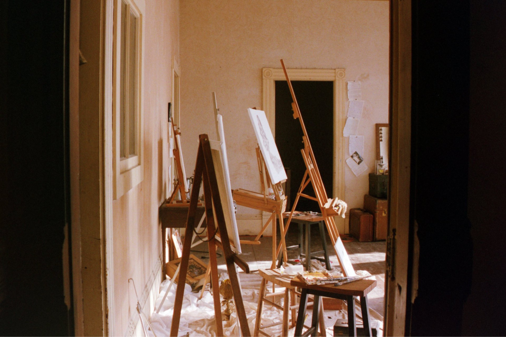 An empty room filled with several easels.