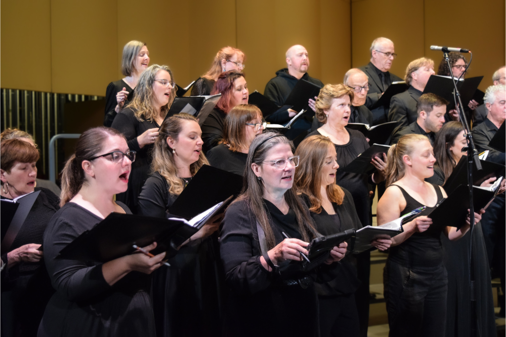 A group of people dressed in black singing.