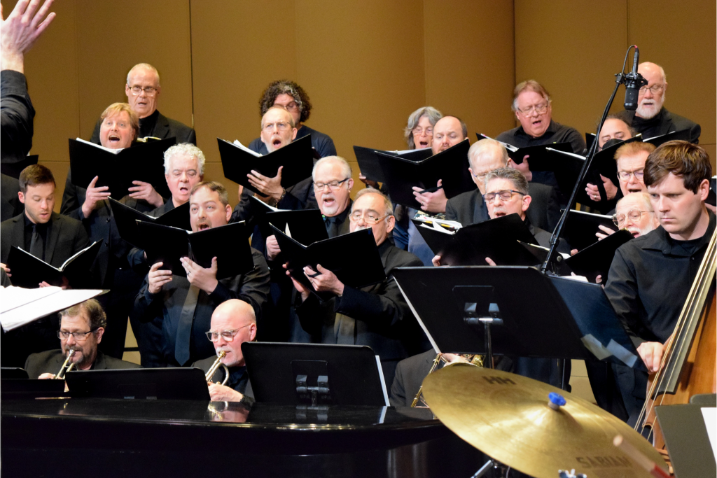 A group of people dressed in black singing.