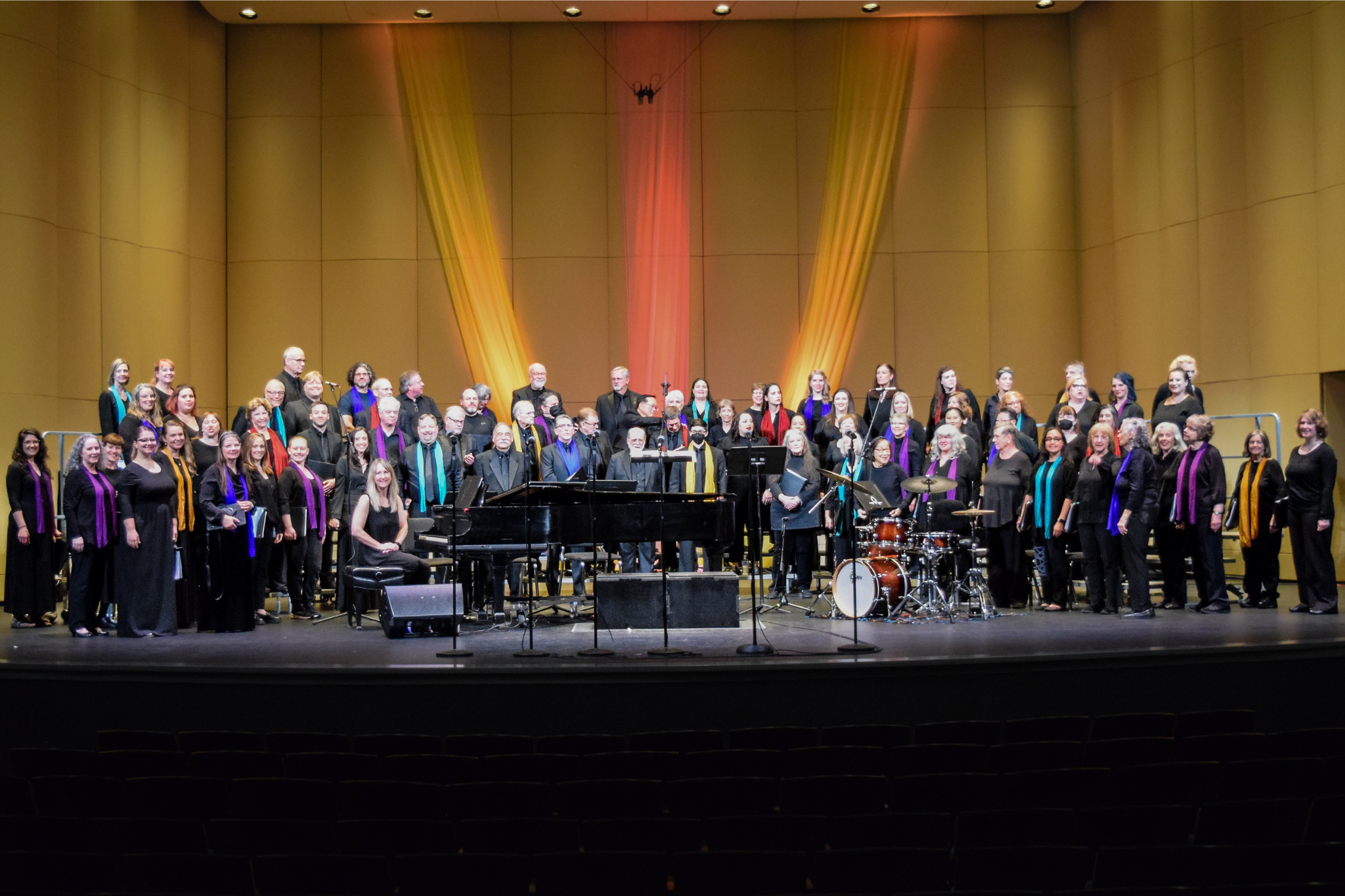 A group of people dressed in colorful outfits singing for a crowd.