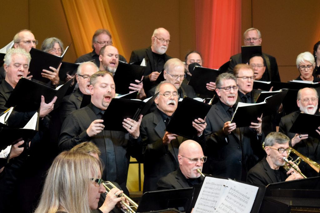 A group of people dressed in black singing.