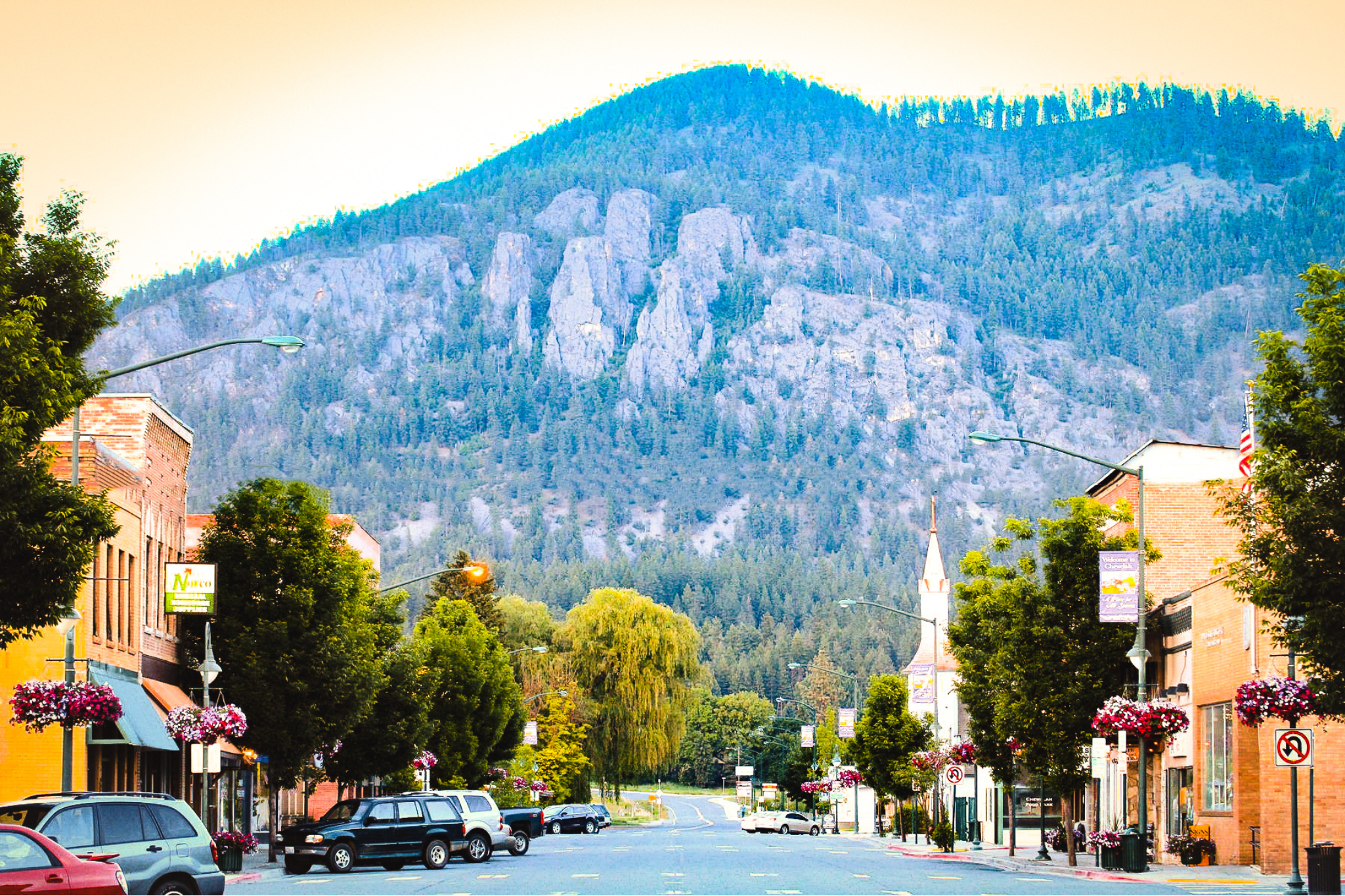 A landscape image of a large hill and a view of the street.