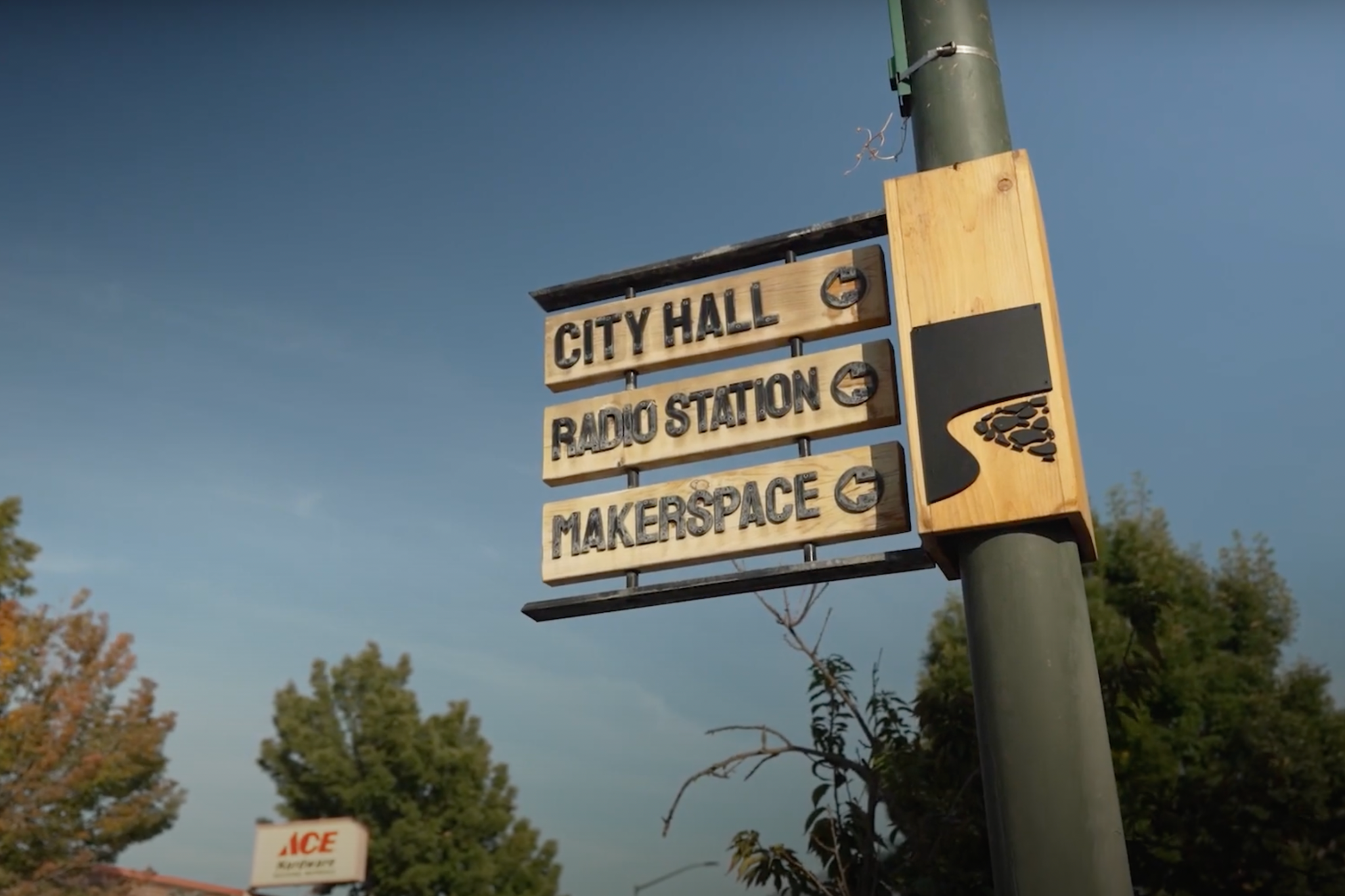 Directional signage that reads, " City Hall, Radio Station, and Makerspace."