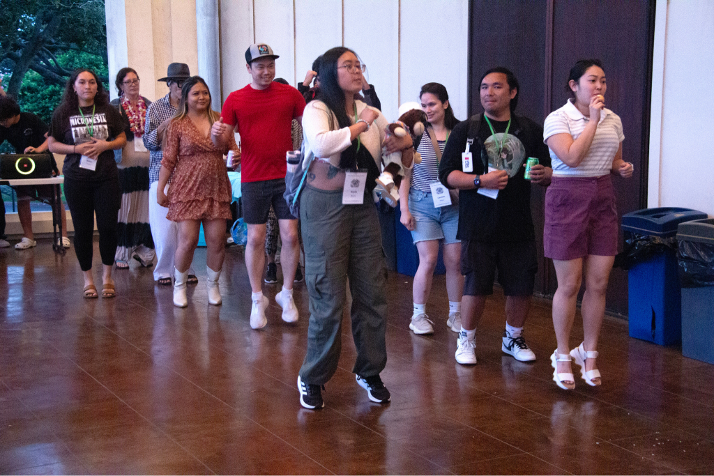 A classroom full of people talking and dancing near each other.